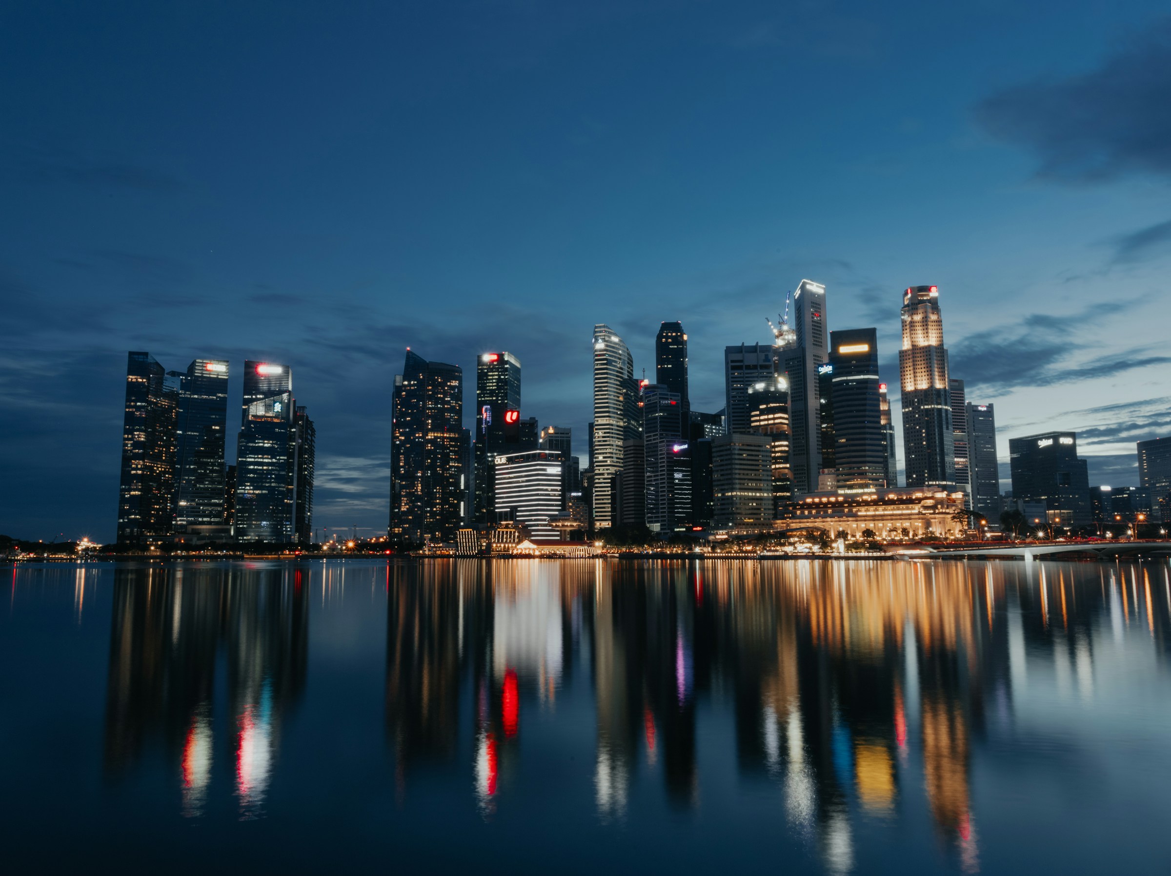 Singapore’s business district across Marina Bay at dusk